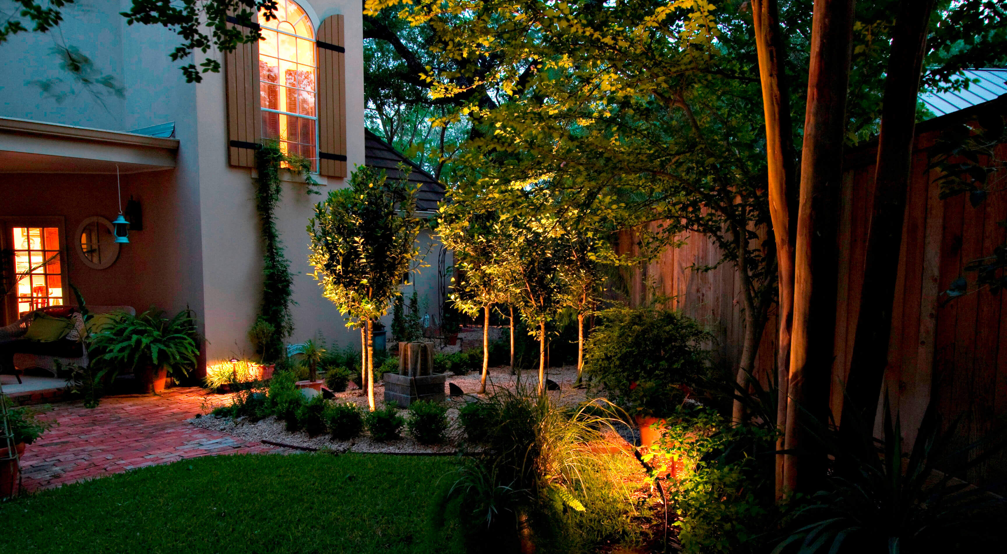 Backyard patio with tree lighting